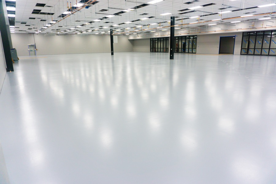Expansive ESD-controlled polymer floor across an electronics manufacturing facility